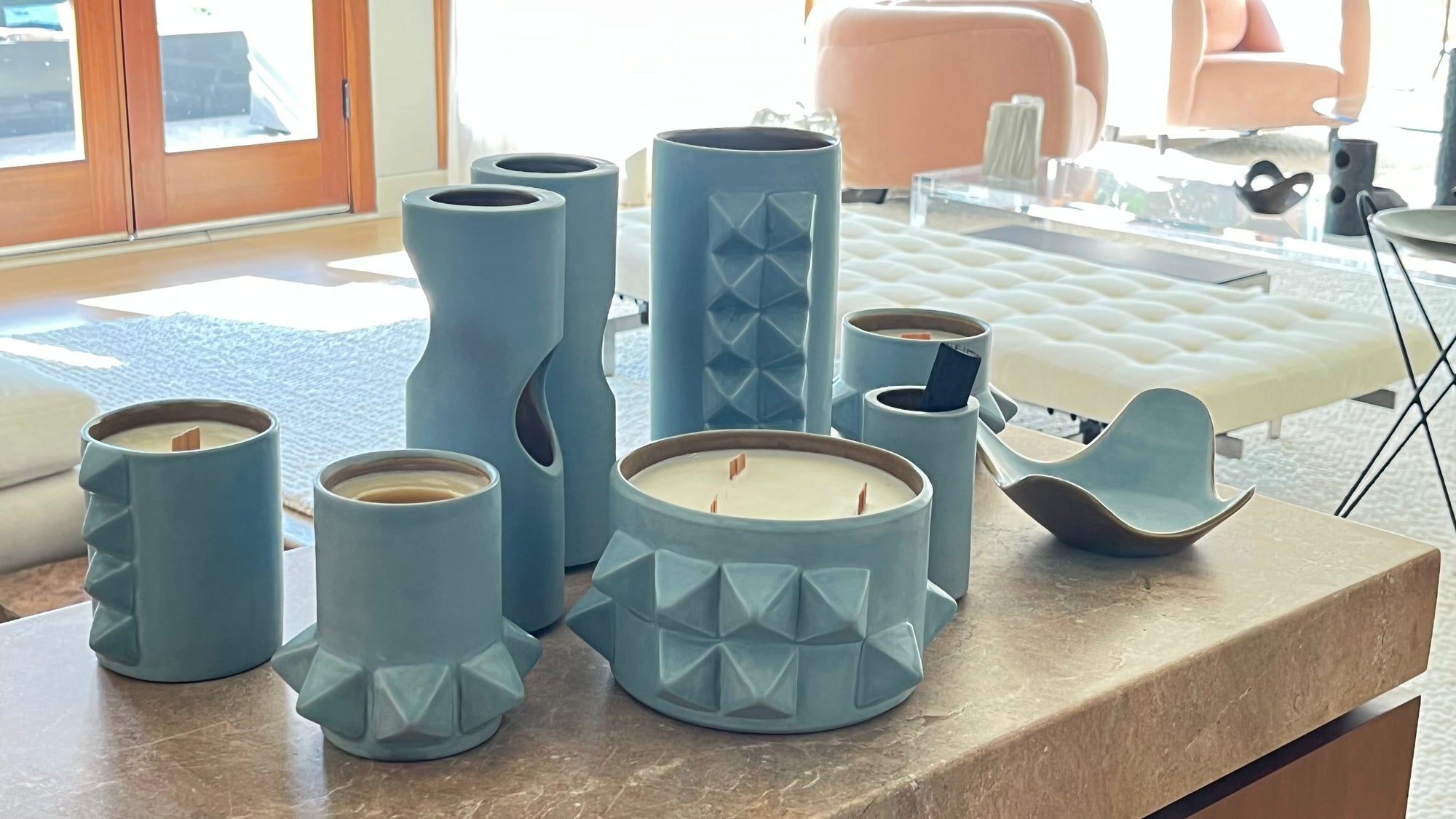 a group of pale blue candles and other vessels