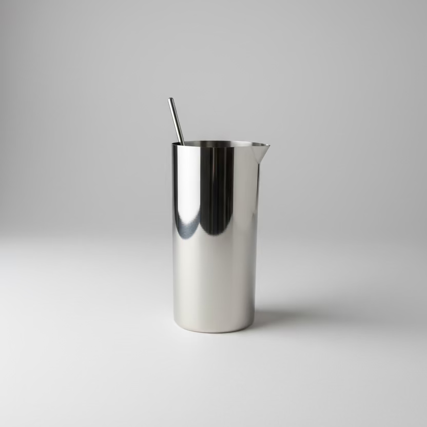 Silver metal cup with a spoon on a wooden surface