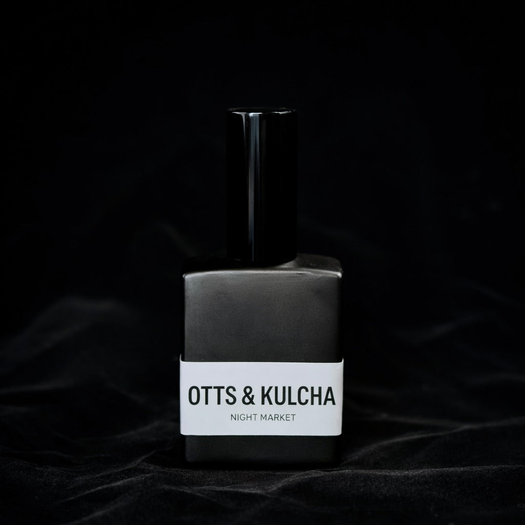 Perfume bottle and packaging with 'OTTS & KULCHA' branding on a dark background